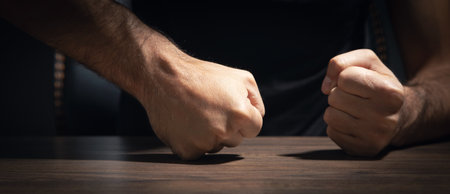 Fists of angry man beats on the table.の写真素材