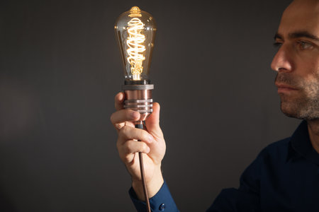 Man showing vintage modern light bulb.