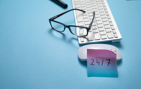 24/7 on sticky note with a computer keyboard.