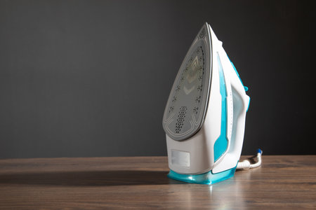 Modern iron on the wooden table.の写真素材