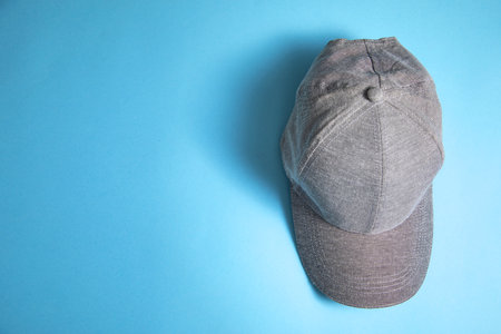 Baseball cap on the blue background.
