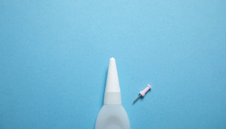 Bottle of glue on the blue background.の写真素材
