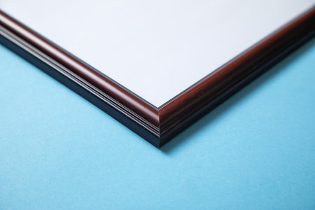 Empty diploma or certificate frame on the blue background.の写真素材