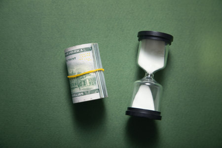 Hourglass and dollar. Time is moneyの写真素材