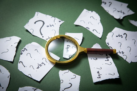 Question marks and Why? word with magnifying glass.の写真素材
