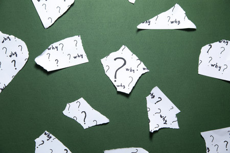 Question marks and Why? word on torn papers.の写真素材