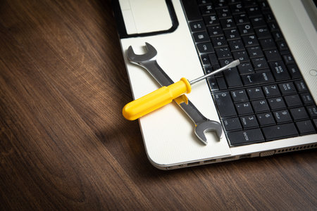 Wrench and screwdriver with a laptop computer. IT Service. Supportの写真素材
