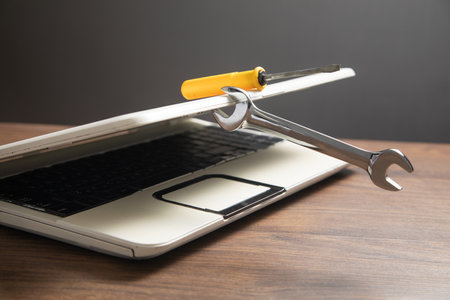 Wrench and screwdriver with a laptop computer. IT Service. Supportの写真素材