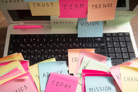 Laptop computer with colorful sticky notes. Businessの写真素材