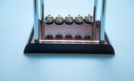 Newton's cradle balls on the blue background.の写真素材