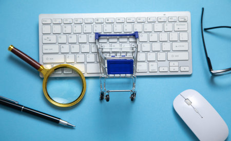 Shopping cart with a computer keyboard and business objects.の写真素材