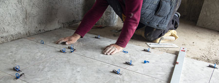 Laying floor tiles. Renovating the floorの写真素材