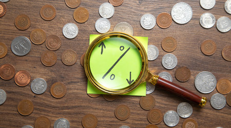 Percentage symbol on sticky note with a coins.