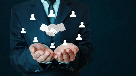 Handshake of business partners with a human symbols. Successful dealの写真素材