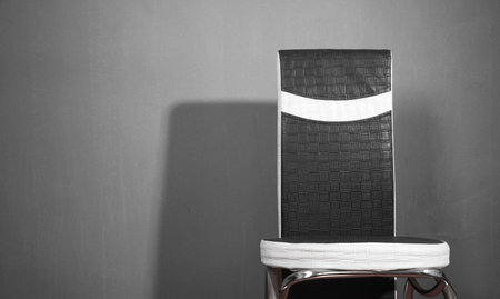 Black and white leather office chair in gray background.の写真素材