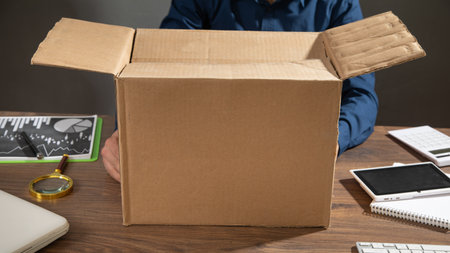Businessman with a cardboard box and business objects. Job loss. Unemployment