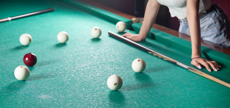 Caucasian young girl playing billiards.の写真素材