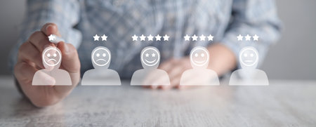 Human icons with positive and sad face, stars. Customer evaluation and satisfactionの写真素材