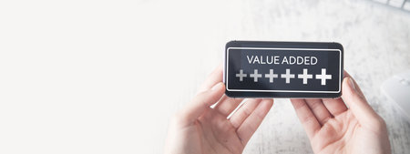 Human hand showing Plus symbols with a word Value Added. Profit, Benefit, Businessの写真素材