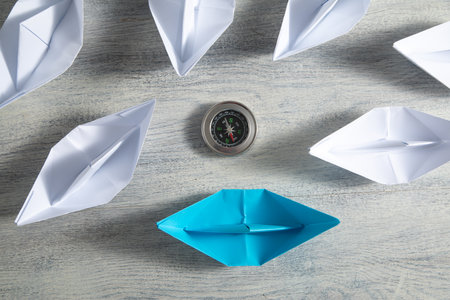 Paper boats with a compass. Business conceptの写真素材