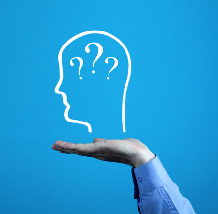 Male hand showing human head with a question marks.の写真素材