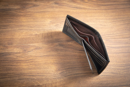 Empty wallet on the wooden table.の写真素材