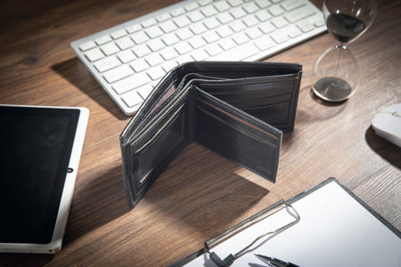 Empty wallet with a business objects on the wooden table.