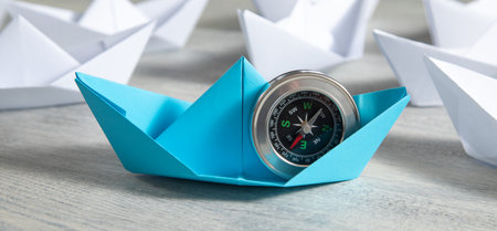 Paper boats with a compass. Business conceptの写真素材