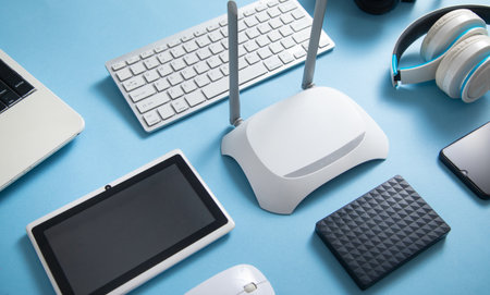 Wi fi router with a tablet, phone, computer keyboard and other objects.の写真素材