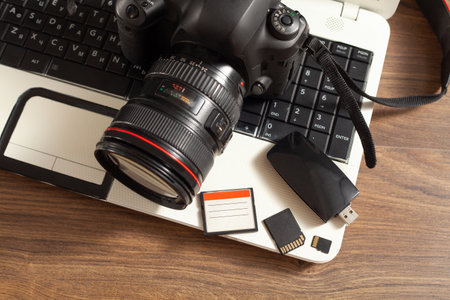 Modern DSLR camera and laptop computer.の写真素材