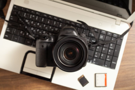 Modern DSLR camera and laptop computer.の写真素材