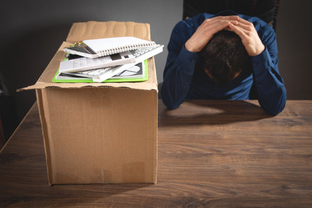 Businessman with a cardboard box and business objects. Job loss. Unemploymentの写真素材