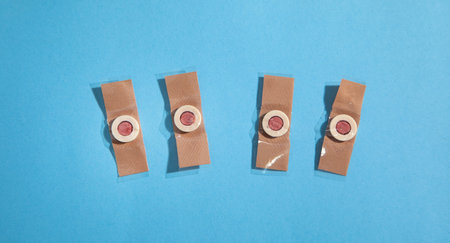 Adhesive bandage on the blue background.の写真素材