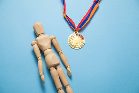 Wooden human figure and medal for winner.の写真素材