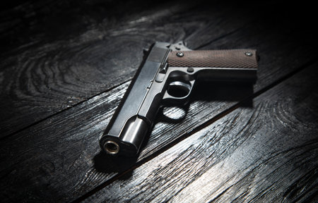 Pistol on jeans pocket on the dark background.の写真素材