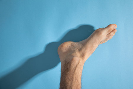 Male barefoot on the blue background.の写真素材