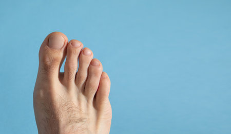 Male barefoot on the blue background.の写真素材
