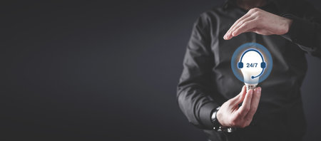 Human showing 24 7 service sign.の写真素材