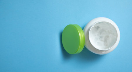 Cream jar on the blue background.の写真素材