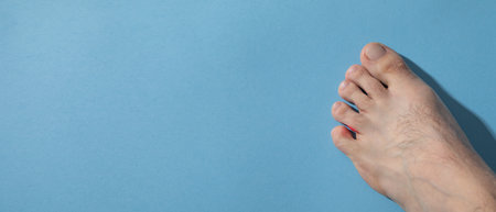 Male barefoot on the blue background.の写真素材