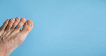 Male barefoot on the blue background.