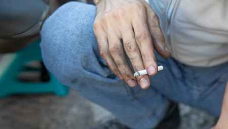 Caucasian man smoking cigarette in the outdoor.の写真素材