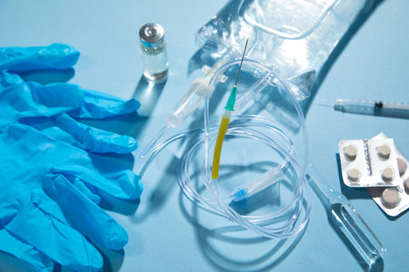 Infusion bag, syringe, medical ampoules in the blue background. IV drip chamberの写真素材
