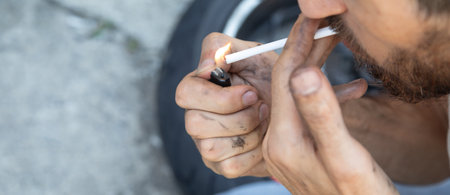 Caucasian man smoking cigarette in the outdoor.の写真素材
