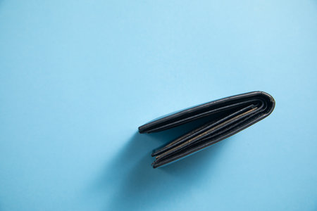 Black wallet on the blue background.