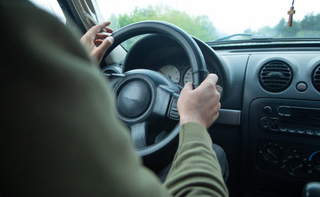 Man driving his car on the way of outdoor.