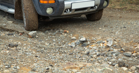 Car wheel in dirty ground road.