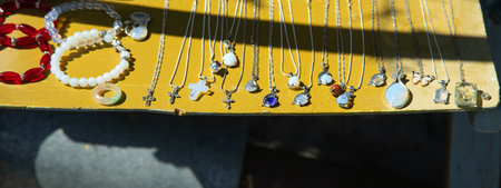 Necklace and bijuterie on the counter of a street.の写真素材