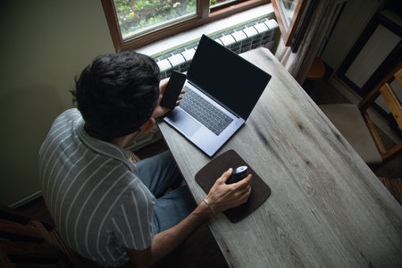 Man working in a computer at home.