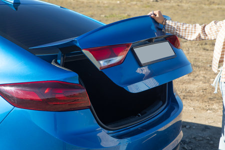 Woman closing car trunk. Transportの写真素材